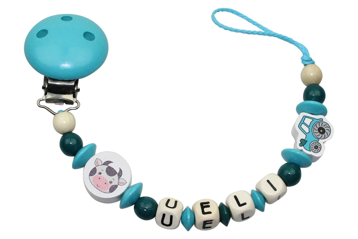 Baby pacifier chain with name Tractor:Cow turquoise